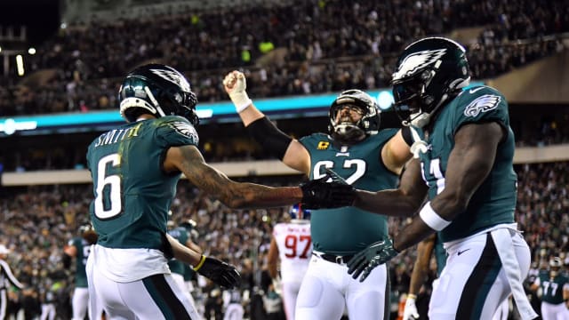 Jason Kelce celebrates with receivers DeVonta Smith and A.J. Brown